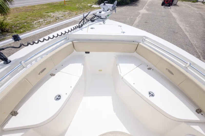 Slide: The Image of 2016 Cobia 201 Center Console boat interior with cushioned seating and storage compartments. - 37