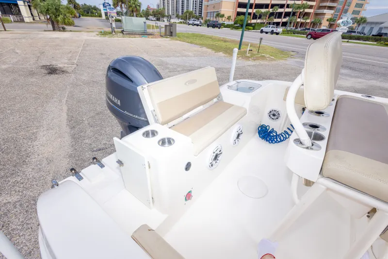 Slide: The Image of 2016 Cobia 201 Center Console boat with Yamaha engine, featuring seating and cup holders. - 43