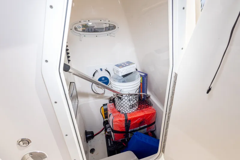 Slide: The Image of Interior storage of 2016 Cobia 201 Center Console boat with equipment and supplies. - 30