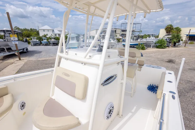 Slide: The Image of 2016 Cobia 201 Center Console boat in a marina with other boats. - 39