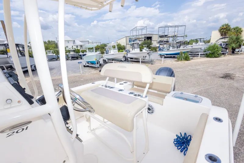 Slide: The Image of 2016 Cobia 201 Center Console boat in a marina with other vessels. - 40
