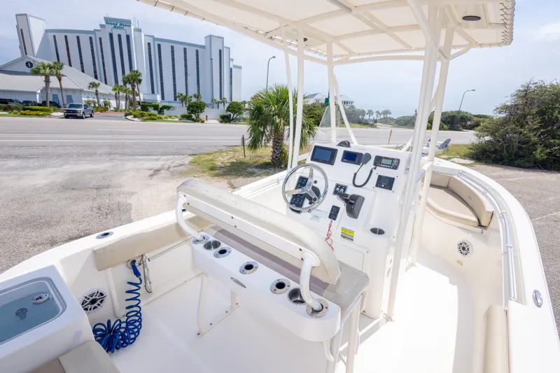 Slide: The Image of 2016 Cobia 201 Center Console boat interior with steering wheel and controls. - 21