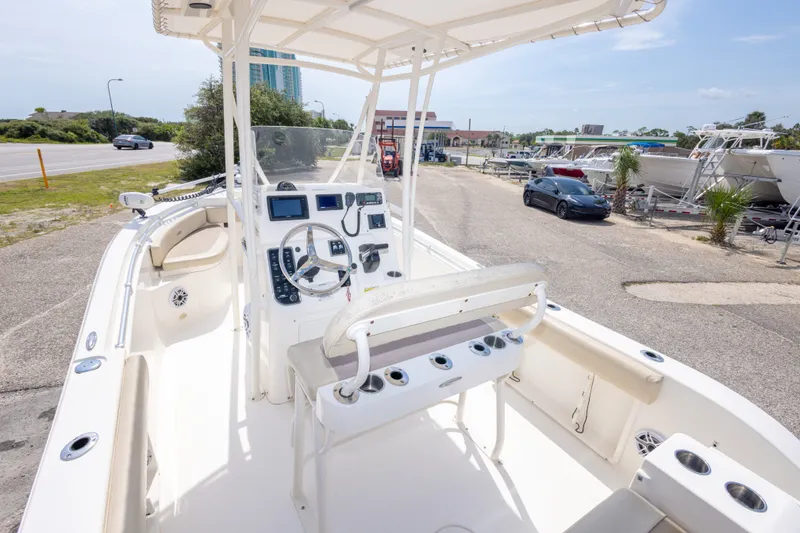 Slide: The Image of 2016 Cobia 201 Center Console boat with steering wheel and navigation equipment. - 22