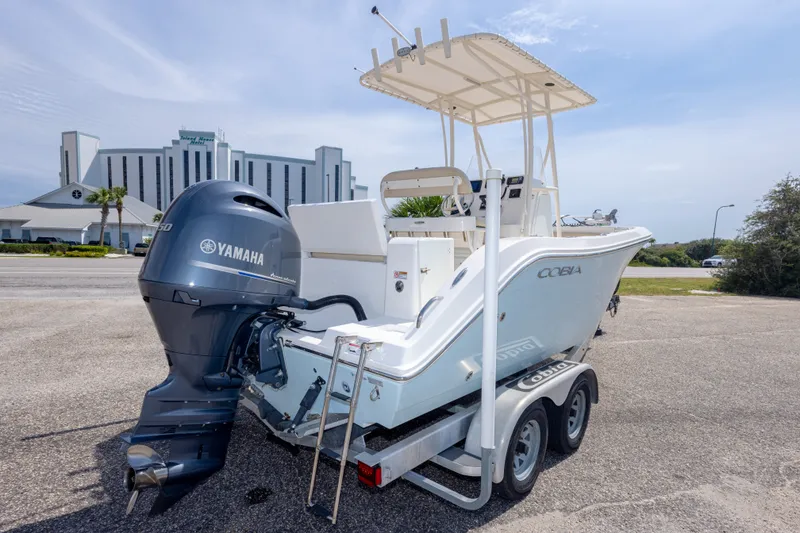 Slide: The Image of 2016 Cobia 201 Center Console boat with Yamaha engine on trailer. - 13