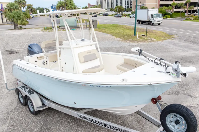 Slide: The Image of 2016 Cobia 201 Center Console boat on trailer in parking lot. - 1