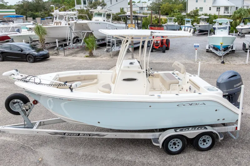 Slide: The Image of 2016 Cobia 201 Center Console boat on trailer in marina setting. - 3