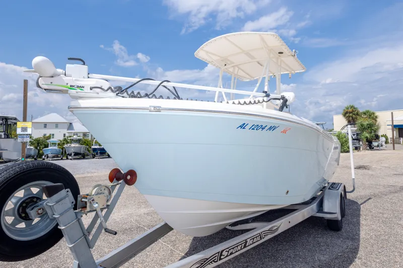 Slide: The Image of 2016 Cobia 201 Center Console boat on trailer under blue sky. - 17