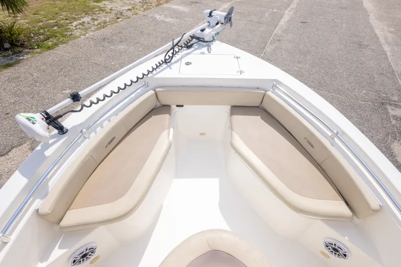 Slide: The Image of 2016 Cobia 201 Center Console boat with cushioned seating and trolling motor. - 31