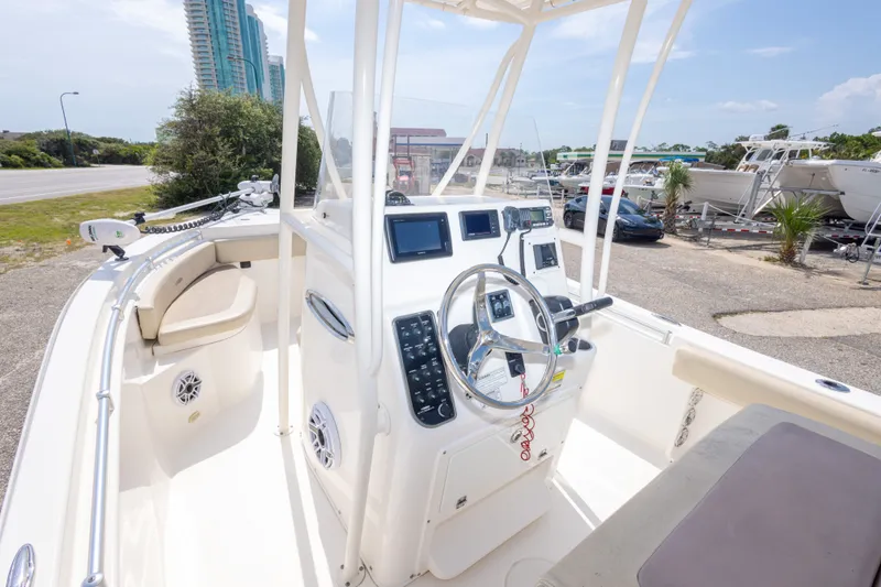 Slide: The Image of 2016 Cobia 201 Center Console boat interior with steering wheel and control panel. - 24