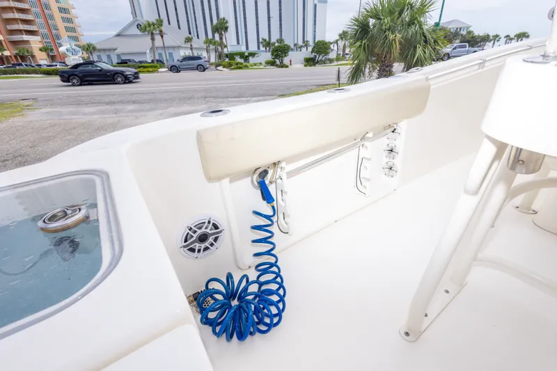 Slide: The Image of 2016 Cobia 201 Center Console boat interior with blue coiled hose and speaker. - 45