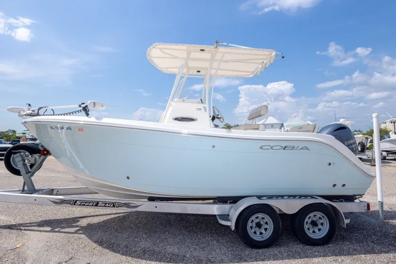 Slide: The Image of 2016 Cobia 201 Center Console boat on trailer under blue sky. - 16