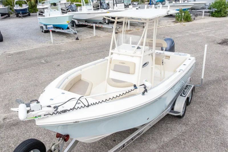 Slide: The Image of 2016 Cobia 201 Center Console boat on trailer in a marina setting. - 4