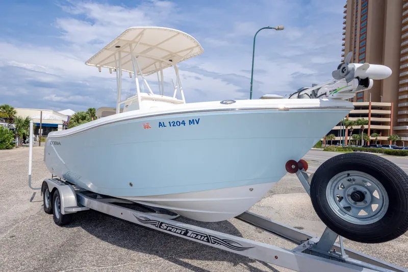 Slide: The Image of 2016 Cobia 201 Center Console boat on trailer, parked outdoors. - 11
