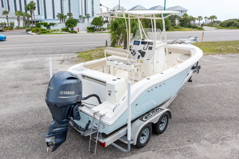 Slide: The Image of 2016 Cobia 201 Center Console boat with Yamaha engine on trailer, parked near road. - 49