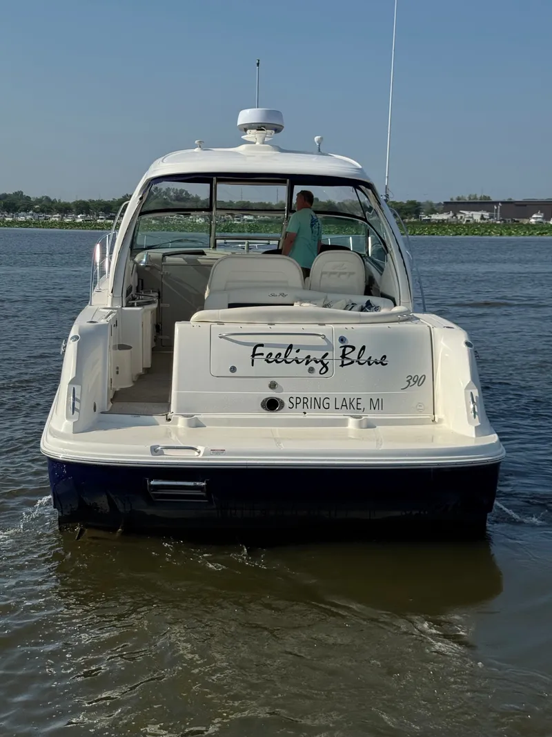 Slide: The Image of A 2005 Sea Ray 390 Sundancer on the water. The name "Feeling Blue" is visible on the stern. - 5