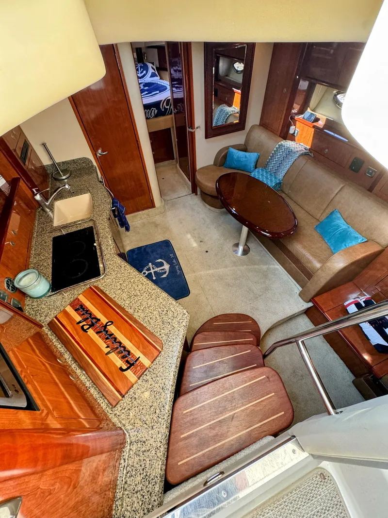 Slide: The Image of Interior of a 2005 Sea Ray 390 Sundancer featuring a kitchen, sofa, and dining table. - 35
