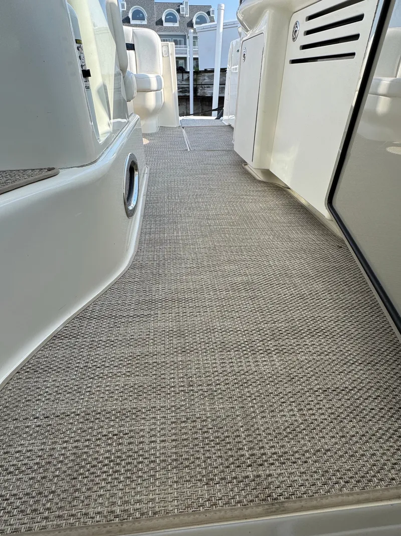 Slide: The Image of The walkway of a 2005 Sea Ray 390 Sundancer with carpeted flooring. - 24