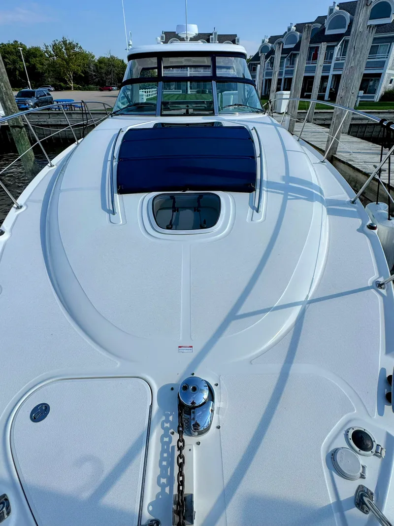 Slide: The Image of The image shows the foredeck of a 2005 Sea Ray 390 Sundancer docked at a marina. - 8