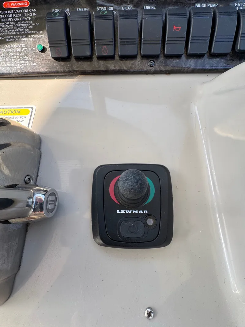 Slide: The Image of Close-up of a control panel featuring a Lewmar joystick and several switches. - 18