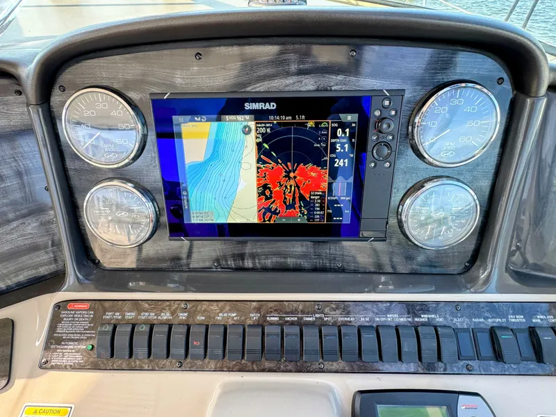 Slide: The Image of The dashboard of a 2005 Sea Ray 390 Sundancer featuring a Simrad navigation system. - 28
