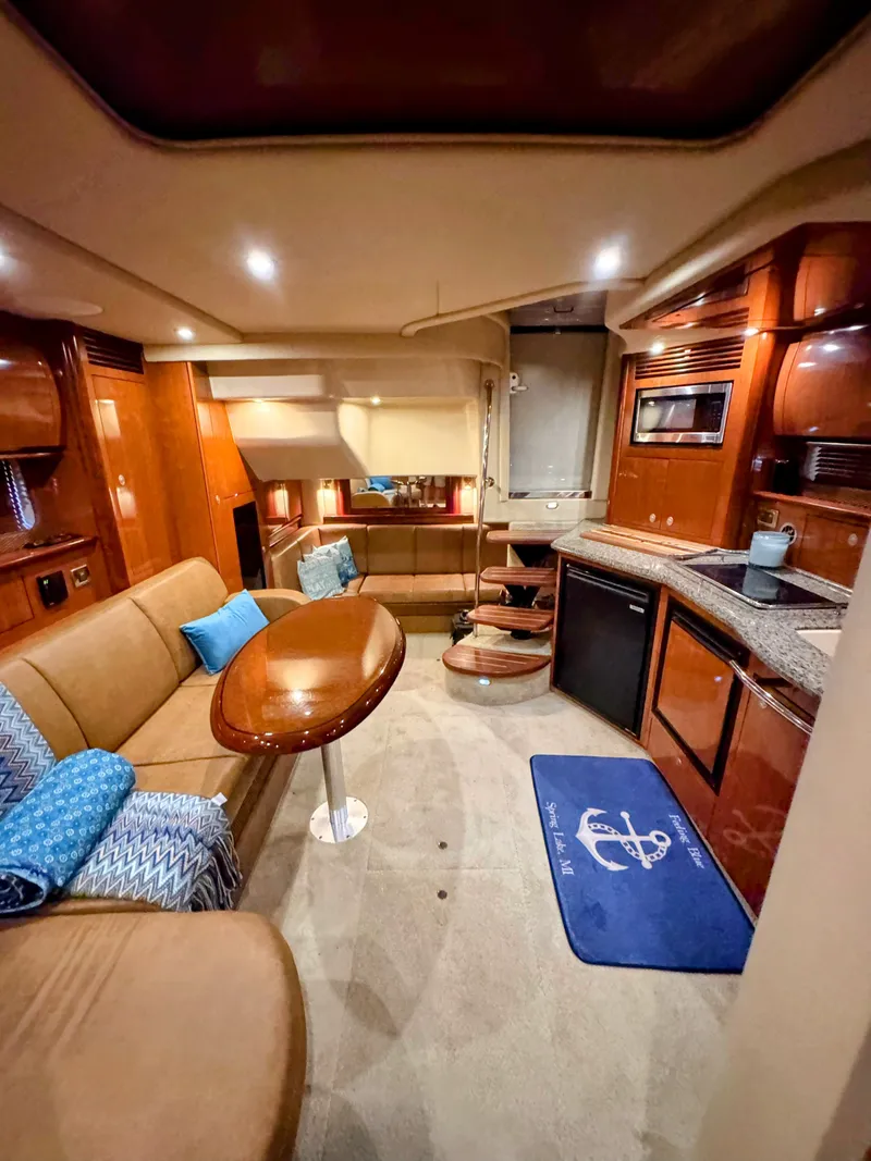Slide: The Image of Interior of a 2005 Sea Ray 390 Sundancer with elegant furnishings and a modern kitchen. - 39