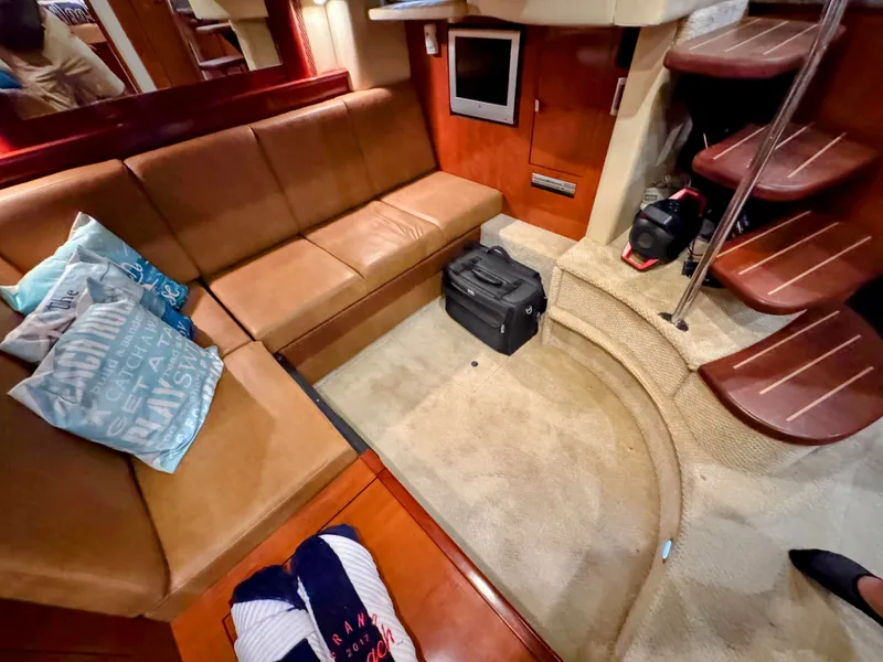 Slide: The Image of Interior of the 2005 Sea Ray 390 Sundancer with leather sofa and carpeted floor. - 45