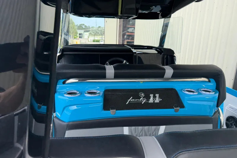 Slide: The Image of Interior view of a 2027 Nor-Tech boat, featuring sleek blue and black seating. - 19