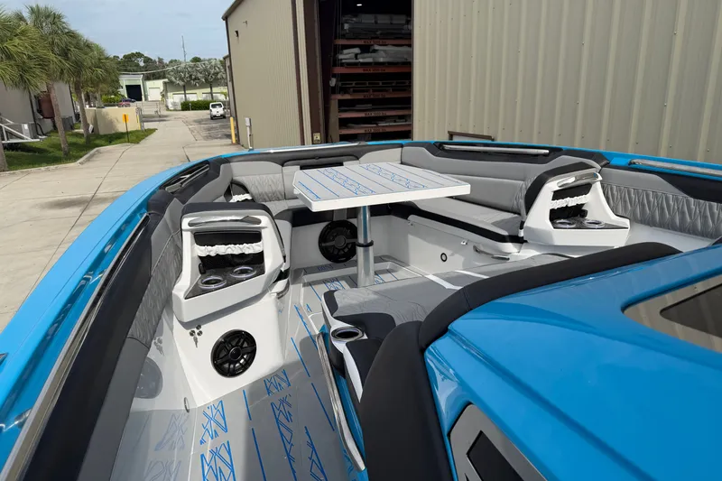 Slide: The Image of Luxurious 2027 Nor-Tech boat interior with blue accents and seating area. - 25