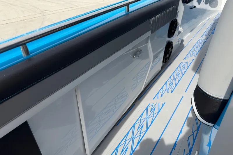 Slide: The Image of 2027 Nor-Tech boat deck with sleek design and blue accents. - 24