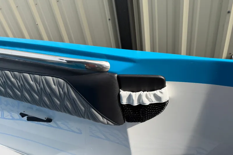 Slide: The Image of 2027 Nor-Tech boat interior detail with blue trim and quilted upholstery. - 32