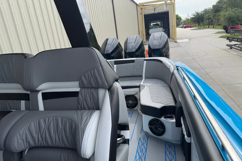 Slide: The Image of 2027 Nor-Tech boat interior with gray seating and powerful outboard engines. - 14