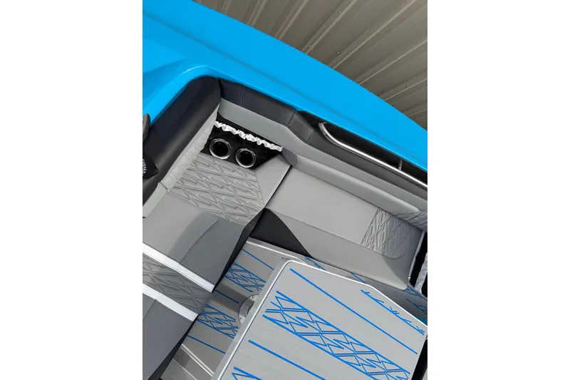 Slide: The Image of Interior of a 2027 Nor-Tech boat with modern gray and blue seating design. - 28