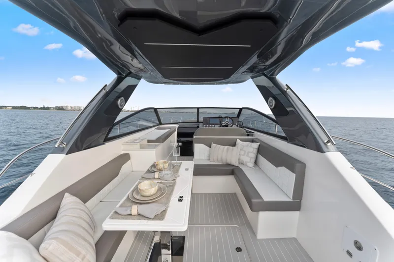 Slide: The Image of Luxurious 2025 Valiatt 380GT yacht interior with elegant seating and dining area on open water. - 12