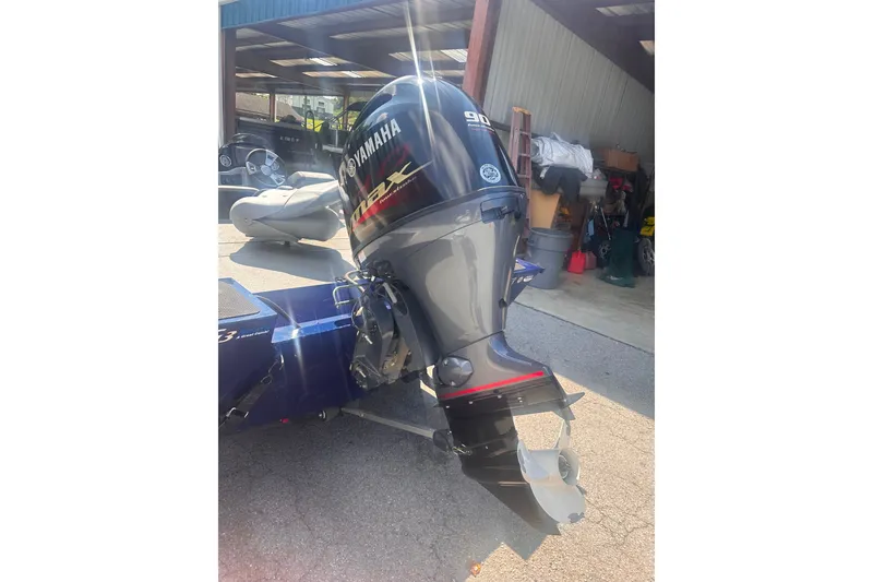 Slide: The Image of 2023 G3 Sportsman 1710 with Yamaha outboard motor in a garage setting. - 10