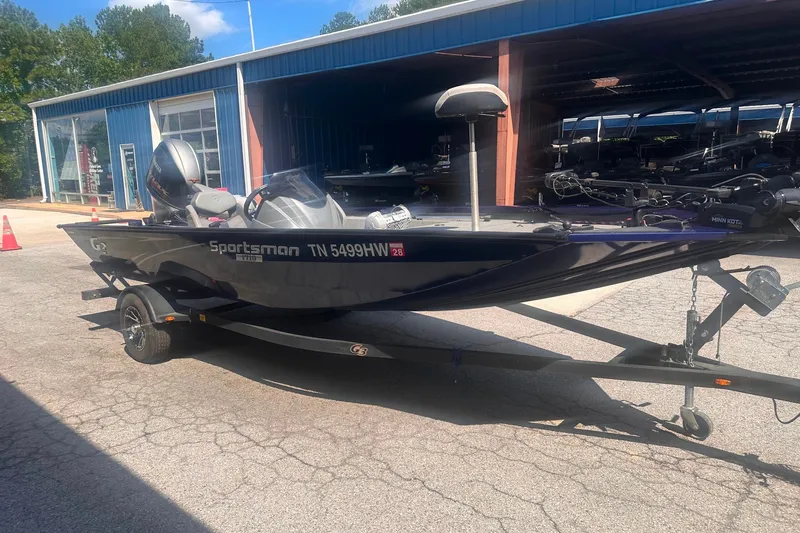 Slide: The Image of 2023 G3 Sportsman 1710 boat on trailer, parked outside a blue building. - 8