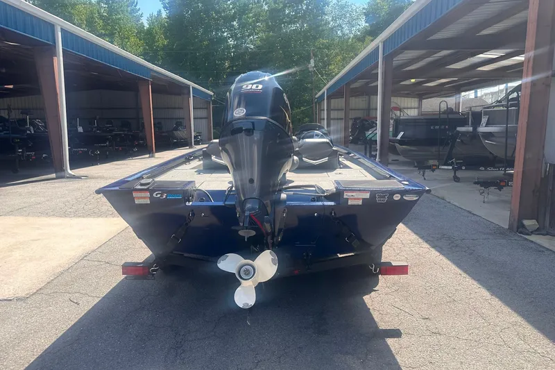 Slide: The Image of 2023 G3 Sportsman 1710 boat with outboard motor in a storage facility. - 1
