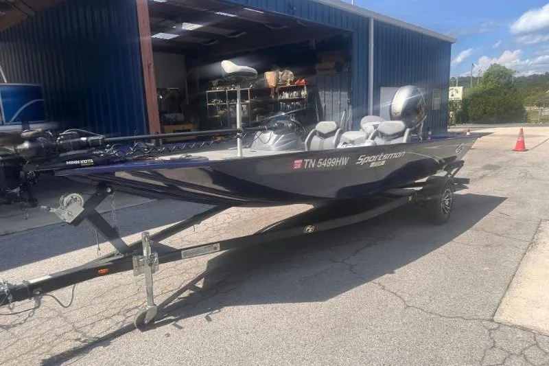 Slide: The Image of 2023 G3 Sportsman 1710 boat on trailer outside a blue building. - 6