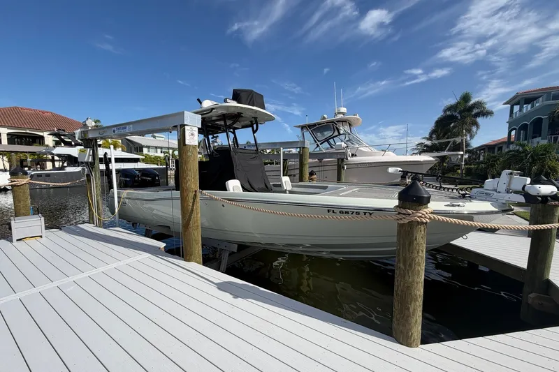 The Image of 2025 Caymas 281 HB boat docked at marina under clear blue sky. - 1