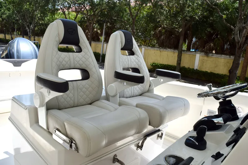 Slide: The Image of Luxury seating on 2023 Sailfish 312 CC boat, featuring plush white upholstery and modern design. - 13