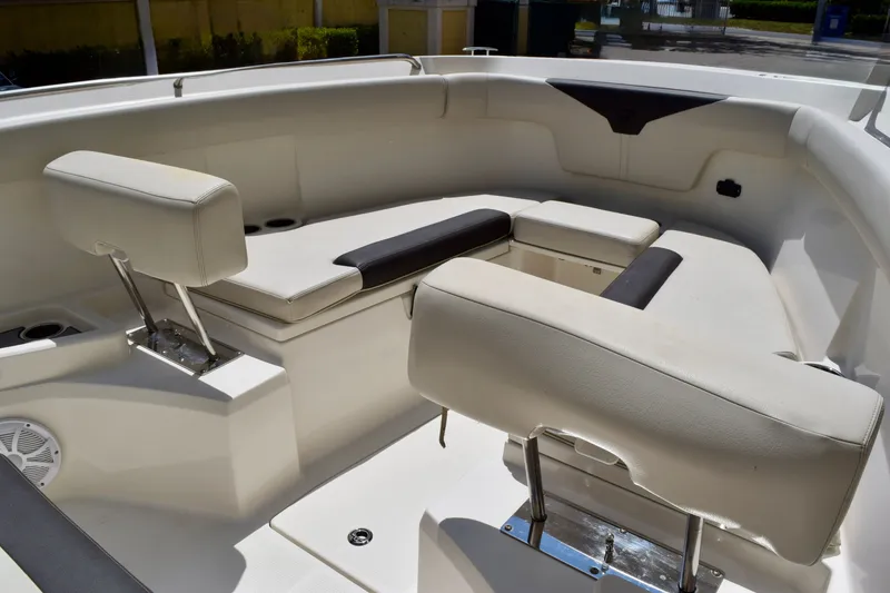 Slide: The Image of 2023 Sailfish 312 CC boat interior with cushioned seating and modern design. - 15