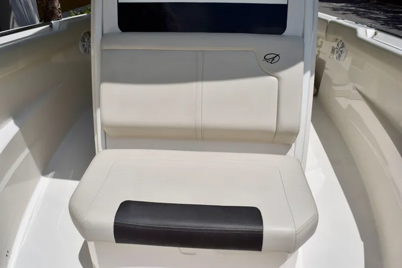 Slide: The Image of 2023 Sailfish 312 CC boat seating area with cushioned bench and sleek design. - 14