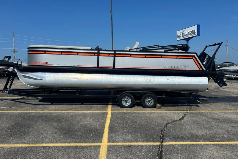 The Image of 2026 Viaggio Lago X-U 24 pontoon boat on trailer in parking lot. - 1