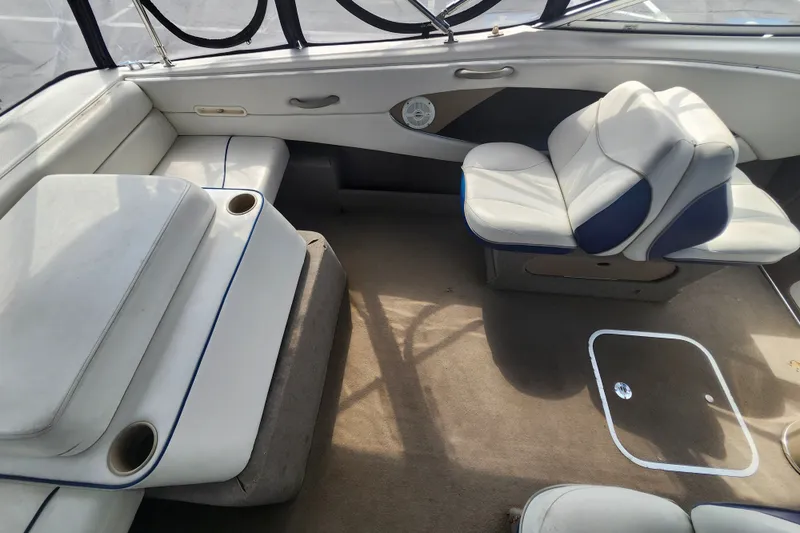 Slide: The Image of Interior of a 2017 Bayliner 210 Cuddy boat with cushioned seating and carpeted floor. - 9