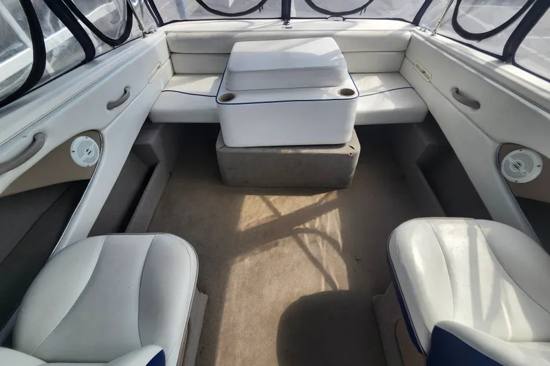 Slide: The Image of Interior of a 2017 Bayliner 210 Cuddy boat with cushioned seating and cup holders. - 10