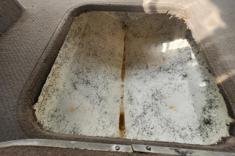 Slide: The Image of Storage compartment of a 2017 Bayliner 210 Cuddy boat, showing interior details. - 14