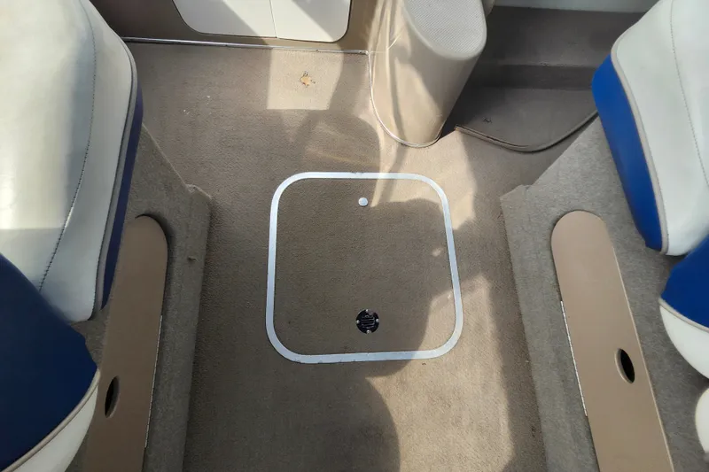 Slide: The Image of Interior of 2017 Bayliner 210 Cuddy boat showing carpeted floor and seating. - 13