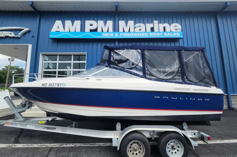 The Image of 2017 Bayliner 210 Cuddy boat on trailer at AM PM Marine dealership. - 1
