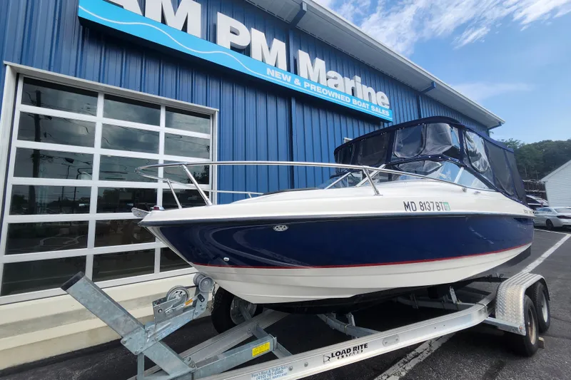 Slide: The Image of 2017 Bayliner 210 Cuddy boat on trailer at AM PM Marine dealership. - 2
