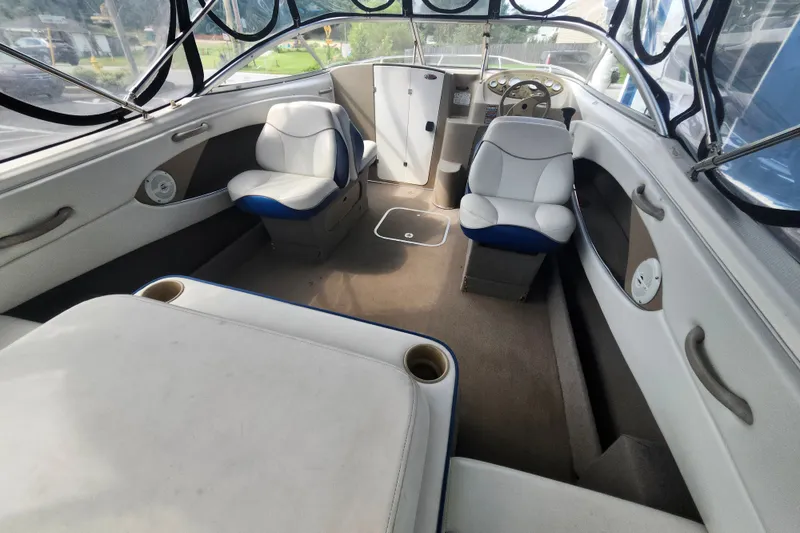 Slide: The Image of Interior of a 2017 Bayliner 210 Cuddy boat with seating and steering wheel. - 7