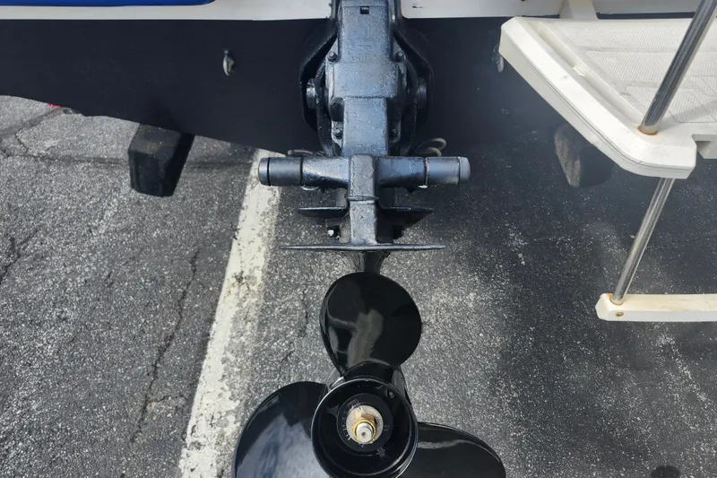 Slide: The Image of 2017 Bayliner 210 Cuddy boat propeller and stern view on pavement. - 5